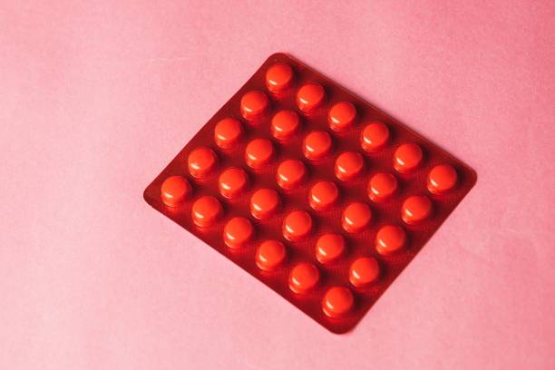 istock Closeup of pills arranged on a pink surface 1479340964