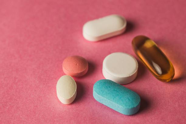 istock Closeup of pills arranged on a pink surface 1479341130
