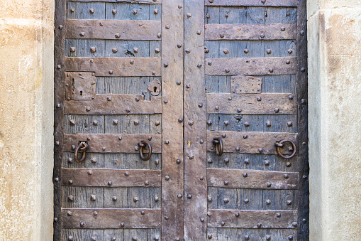 A closeup of a medieval-style old wooden door