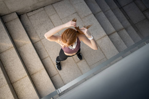 istock Red-haired young female athlete stretches after training 1479343651