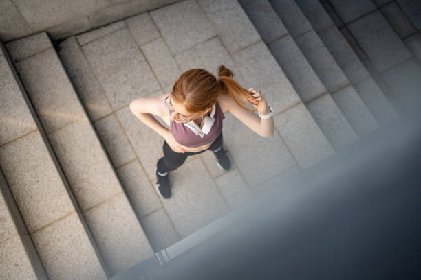 istock Red-haired young female athlete stretches after training 1479343682