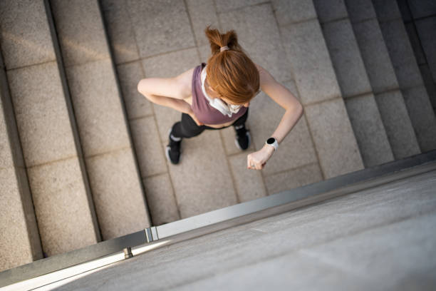 istock Smiling young beautiful redhead woman checking her physical activity on smart watch 1479343744
