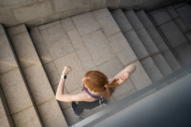 istock Smiling young beautiful redhead woman checking her physical activity on smart watch 1479343745