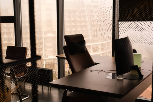 istock empty desks of IT company managers in a modern glass office 1479344934