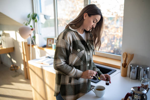 istock Woman adding CBD oil into drink 1479345482