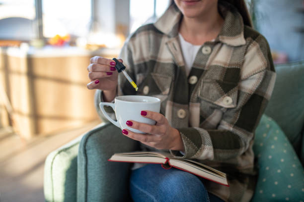 istock Woman adding CBD oil into drink 1479345812