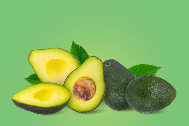 istock Green ripe avocado isolated on a green background. Fruit minimal concept and copy space. 1479346116