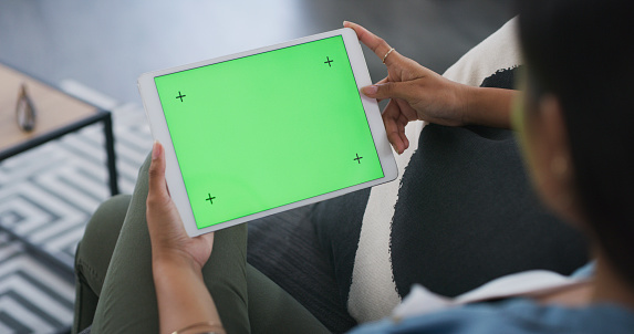 Tablet mockup, green screen and woman in home of advertising space, network app or tracking. Digital technology, mock up and female in house download multimedia, ebook or website platform coming soon