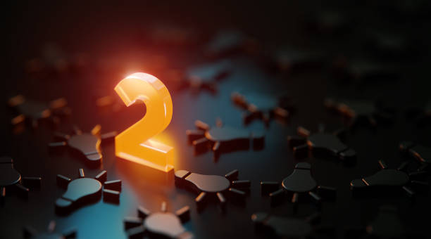 istock Orange Number Two Glowing Amid Black Lightbulb Symbols On Black Background 1479348246