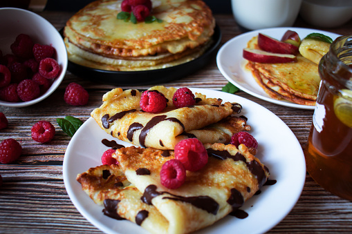 Delicious pancakes with berries and honey. Sweet food.
