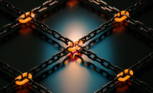 Orange glowing chains connecting multiple chains on black background. Horizontal composition with copy space.