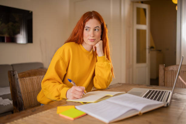 istock Happy young woman is learning online 1479348416