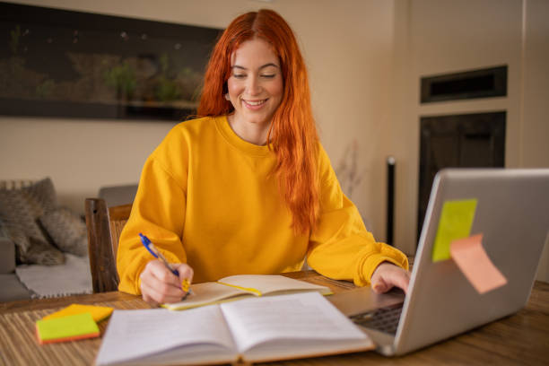 istock Happy young woman is learning online 1479348448