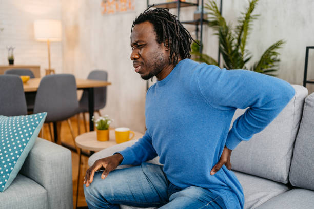 istock Young Man Having Back Pain While Sitting On The Sofa At Home 1479350952