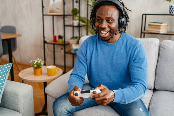 istock Young Man Playing Video Games At Home 1479351178