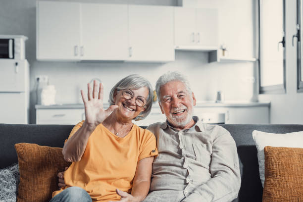 istock Sixty years couple, elderly parents communicates with grown up children using modern technologies makes video call, wave hands gesture of hello or goodbye sign, older generation and internet concept 1479351180