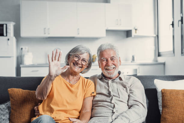 istock Sixty years couple, elderly parents communicates with grown up children using modern technologies makes video call, wave hands gesture of hello or goodbye sign, older generation and internet concept 1479351717