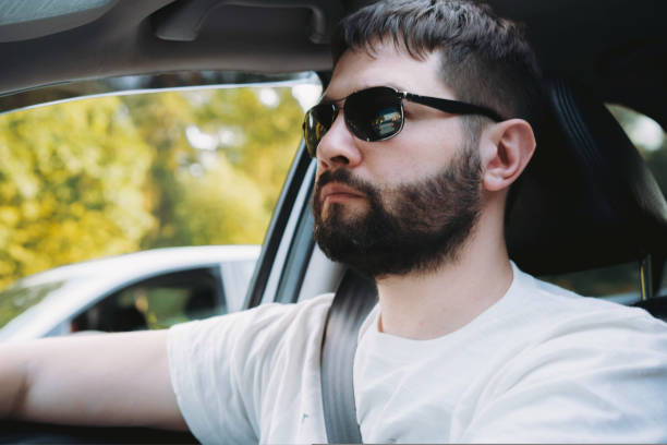 istock caucasian bearded man in sunglasses driving car 1479351746