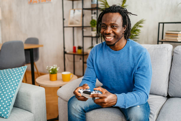 istock Young Man Playing Video Games At Home 1479352418