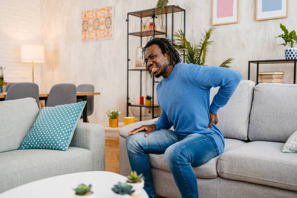 istock Young Man Having Back Pain While Sitting On The Sofa At Home 1479352613