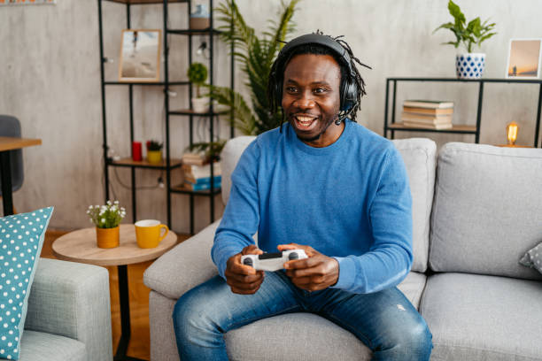 istock Young Man Playing Video Games At Home 1479354218