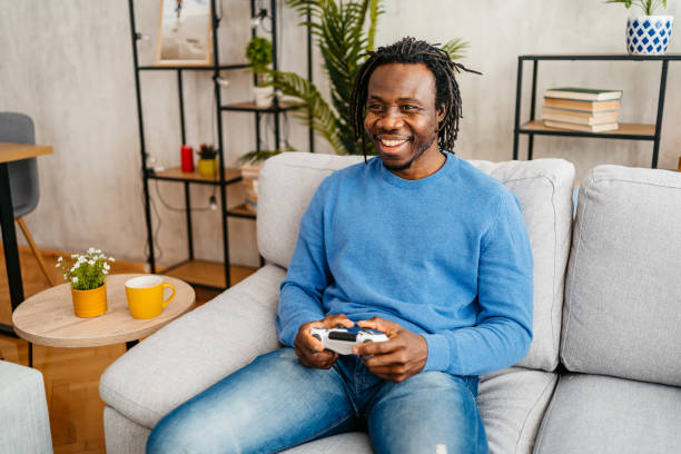 istock Young Man Playing Video Games At Home 1479354864