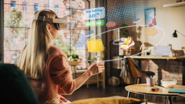 istock Woman at Home, Using Virtual Reality Headset for Online Shopping, Browsing through Pictures of Stylish Brand Shoes and Handbags. Scrolling Mock-up Internet Clothing Store App for e-Commerce products 1479354934
