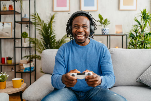 istock Young Man Playing Video Games At Home 1479356024