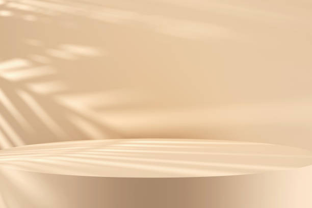 Close up round pastel cream colored podium with tree leaf shadows and natural sunlight.