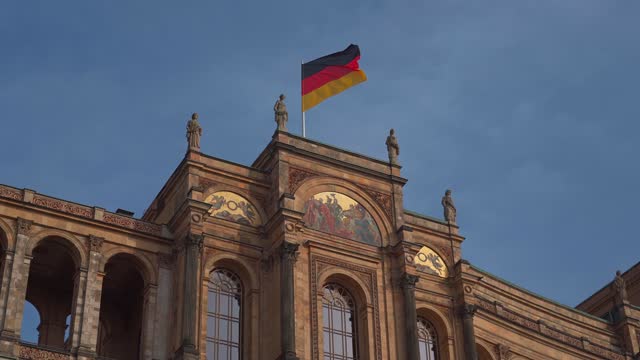 Maximilianeum during renovation and reconstruction. The Bavarian state parliament with flags in Munich, Bavaria, Germany. Bayerischer Landtag Reparatur und Wiederaufbau. Parliament of Bayern.