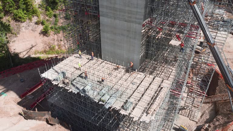 Professional builders work on support structure foundation