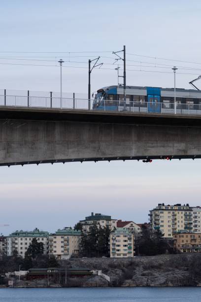 istock Modern passenger train is travelling across a bridge in a picturesque rural setting 1479362819
