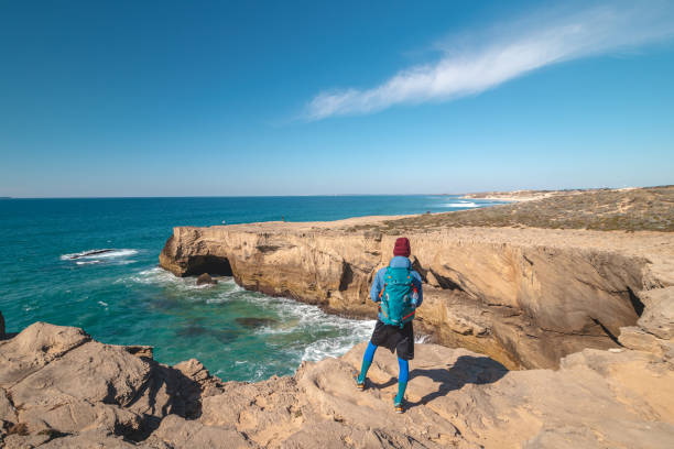 istock Passionate young backpacker tracks rocky cliffs on the Atlantic coast near Vila Nova de Milfontes, Odemira, Portugal. In the footsteps of Rota Vicentina. Fisherman trail 1479363110