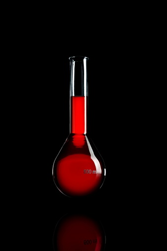A Chemical Glasswork Red Fluid isolated on a Black Background