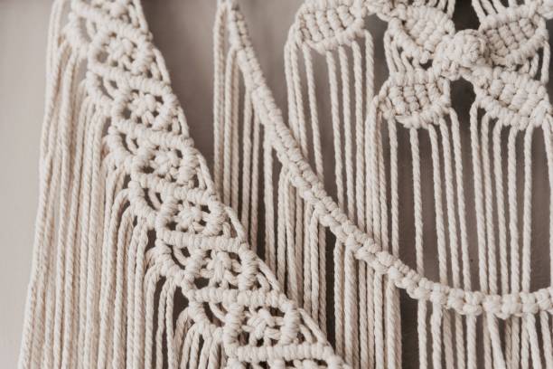 istock Closeup of delicate macrame hangings isolated on white background 1479365001