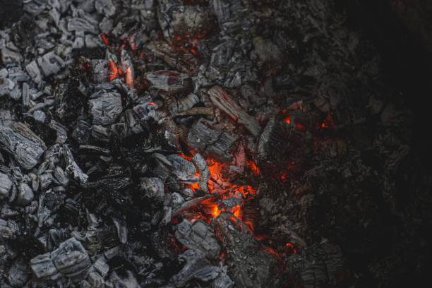 istock Closeup of burning charcoal and flames in dark setting 1479365236
