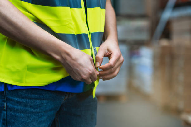 istock Selective focus shot of a male worker buttoning his yellow uniform in a warehouse 1479365263
