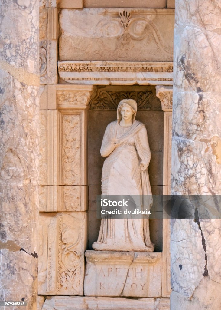An ancient marble statue of a woman in a toga. Part of the exterior of The Celsus Library of Ephesus Ancient City. Ephesus Stock Photo