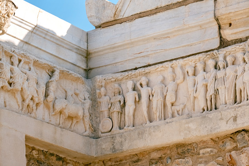 Close-up of a pattern depicting human figures at the Temple of Hadrian at the Ephesus archaeological site in Turkey.