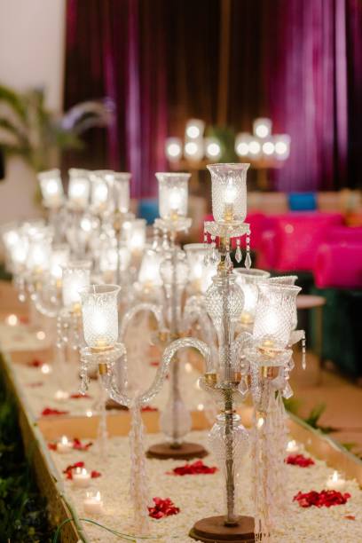 istock Elegantly set wedding table with lit candles and a selection of romantic petal decorations in center 1479367500