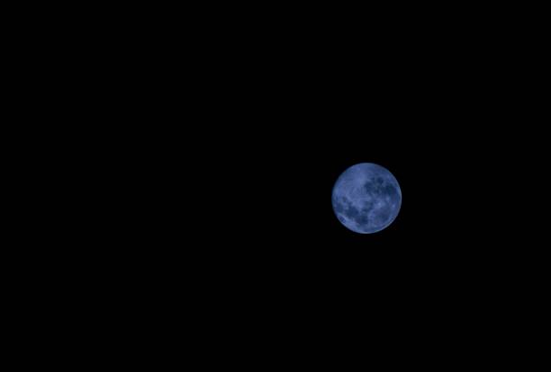 istock Majestic blue full moon illuminates a dark night sky 1479368630
