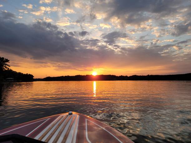 istock Small vessel traversing a tranquil lake at dusk, surrounded by lush forests and peaceful mountains 1479369349