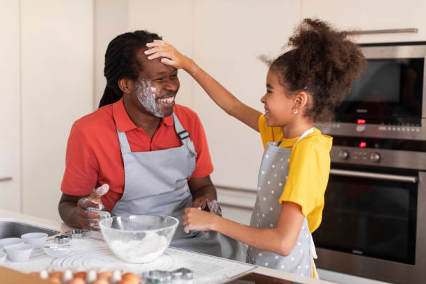 istock Cheerful African American Dad And Daughter Having Fun While Baking In Kitchen 1479369572