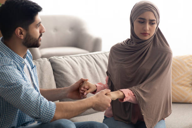 istock Unhappy Islamic Spouses Holding Hands Sitting At Home 1479370206