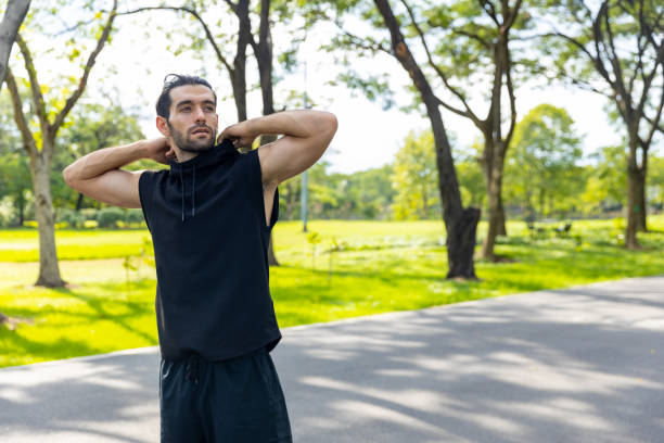 istock Caucasian man stretching body and warm up exercise at public park. 1479370700