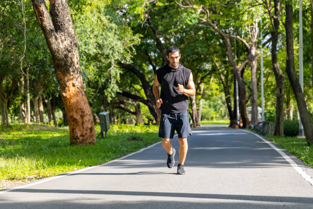 istock Caucasian man jogging exercise at public park in the morning. 1479371007