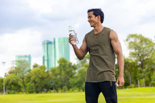 istock Asian man drinking water during jogging exercise at park in the morning. 1479371180