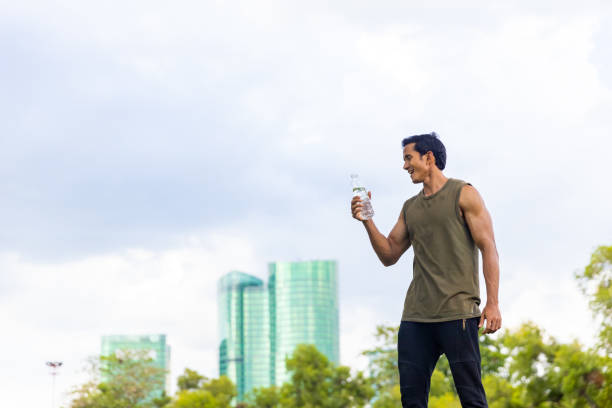 istock Asian man drinking water during jogging exercise at park in the morning. 1479371199