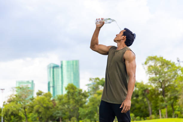 istock Asian man drinking water during jogging exercise at park in the morning. 1479371300