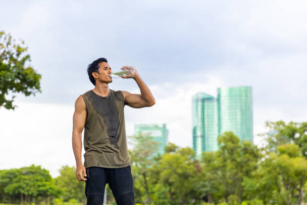 istock Asian man drinking water during jogging exercise at park in the morning. 1479371304